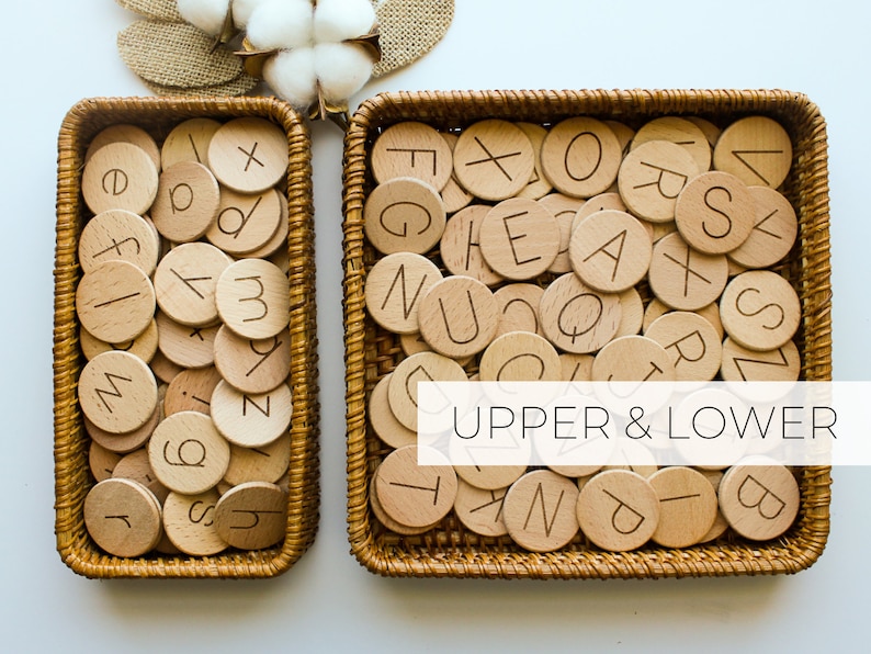 May include: Two wicker baskets filled with wooden alphabet tiles. The tiles have both uppercase and lowercase letters. The text "UPPER & LOWER" is printed on the image.