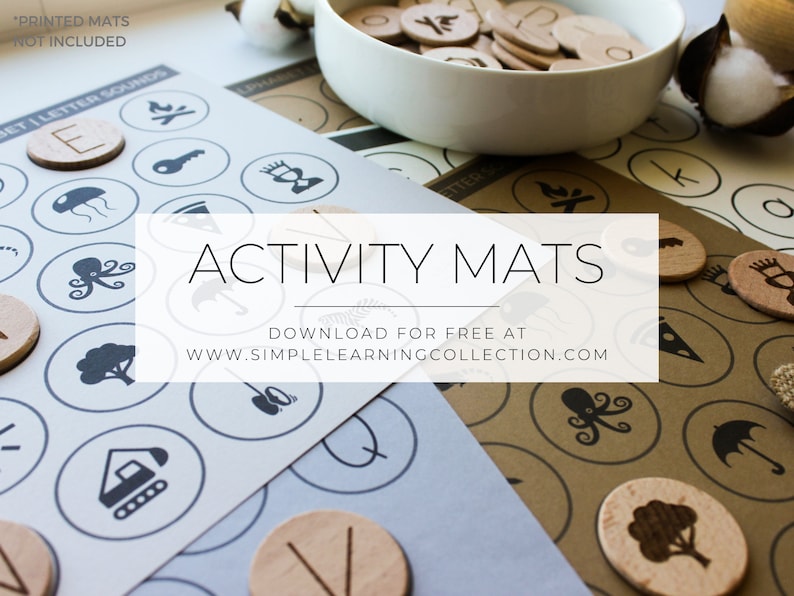 May include: A set of printable activity mats with various images, such as a jellyfish, octopus, and a tree. The mats are designed for use with wooden tokens, which are shown in a bowl in the background. The text "ACTIVITY MATS" is displayed in a white rectangle in the center of the image. The text "DOWNLOAD FOR FREE AT WWW.SIMPLELEARNINGCOLLECTION.COM" is displayed below the title.