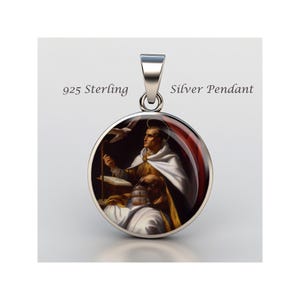 May include: A silver pendant with a round image of a saint holding a book and a dove. The pendant is made of 925 sterling silver and has the words "Silver Pendant" printed on the back.