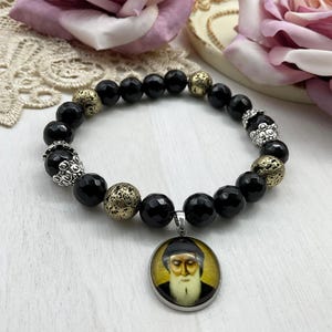 St Charbel Catholic Stretch Bracelet | Black Onyx and Gold Lava Stone Saint Charbel Charm Pendant