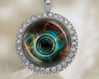 May include: A silver pendant with a round, clear crystal bezel set with a colorful abstract design. The design features swirling lines of blue, green, yellow, and red.