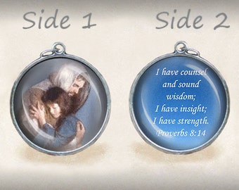 May include: Two-sided pendant with a blue background. One side features a painting of a man holding a child. The other side has a white inscription that reads "I have counsel and sound wisdom; I have insight; I have strength. Proverbs 8:14".