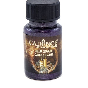 May include: A small bottle of purple metallic candle paint by Cadence Art & Hobby Paints. The bottle has a black cap and a label that says "Mum Boyasi Candle Paint".