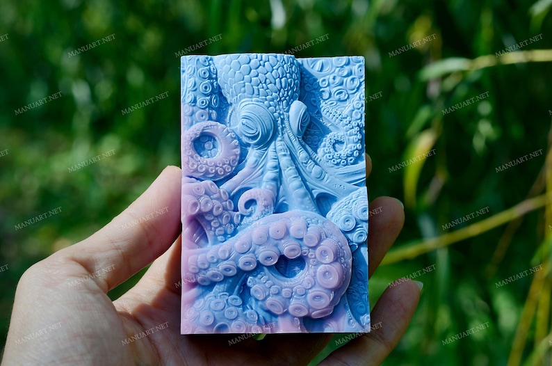 May include: A blue and purple silicone mold of an octopus with detailed tentacles. The mold is designed for making soap, resin, or other crafts.