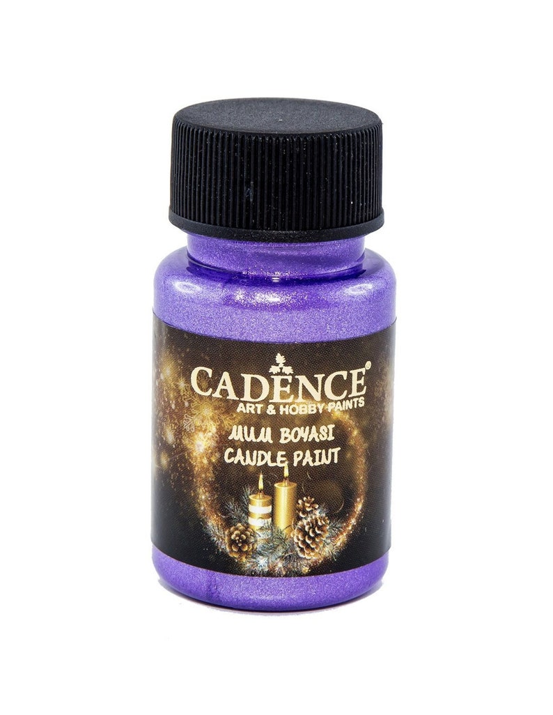 May include: A small bottle of purple metallic candle paint by Cadence Art & Hobby Paints. The bottle has a black lid and a label with the brand name and the words "Mum Boyasi Candle Paint".