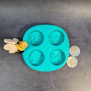 Create detailed small ritual pieces with this witchcraft symbols mold for tealight candles, designed with 4 cavities: Triskelion, Triple Moon, Pentagram, and Triquetra. This food grade silicone candle mold is sized to match US and EU tealight standards.
Candle mold, wiccan mold, pagan mold, Celtic molds, metaphysical mold, pagan silicone mold, wax melts mold, witchcraft mold, symbols mold, mold for tealight, magic mold, spiritual mold, wicca mould