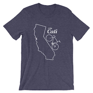 May include: Navy blue t-shirt with a white graphic of the California state outline and a bicycle. The text "ride Cali" is above the bicycle. The shirt is made of a soft material.
