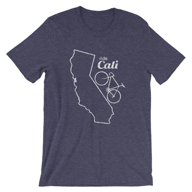 May include: Navy blue t-shirt with a white graphic of the California state outline and a bicycle. The text "ride Cali" is above the bicycle. The shirt is made of a soft material.