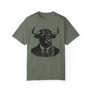 May include: A green t-shirt with a black and white illustration of a bull wearing sunglasses and a suit and tie.