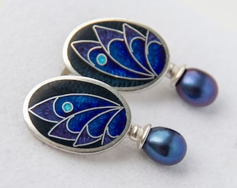 May include: A pair of silver earrings with blue and purple enamel designs and black pearl drops.