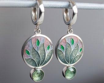 May include: Silver hoop earrings with a green and pink enamel floral design and a green gemstone dangle.