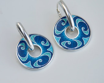 May include: A pair of silver hoop earrings with blue and green enamel. The enamel design is a swirling pattern.