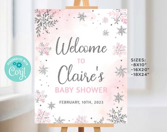 May include: A pink and gray welcome sign with snowflakes and a watercolor background. The sign says "Welcome to Claire's Baby Shower" and "February 10th, 2023". The sign also lists sizes: 8x10 inches, 16x20 inches, and 18x24 inches.