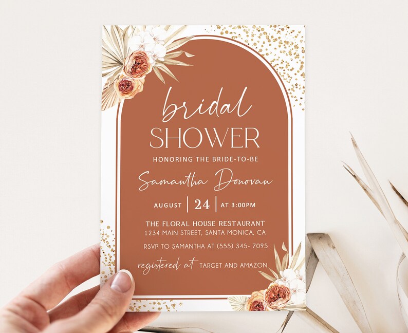 May include: A bridal shower invitation featuring a terracotta arch design. The text reads "bridal SHOWER" and includes details for Samantha Donovan's shower on August 24th at 3:00 PM. Floral accents and gold glitter complete the design.