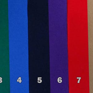 May include: A collection of ten strips of felt in various colors, including yellow, green, blue, navy, purple, red, tan, gray, and black. Each strip is labeled with a number from 1 to 10.