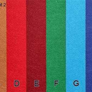 May include: A color chart of felt fabric swatches in various colors, including white, tan, brown, red, burgundy, green, light blue, dark blue, navy, and black. Each color is labeled with a letter from A to J.