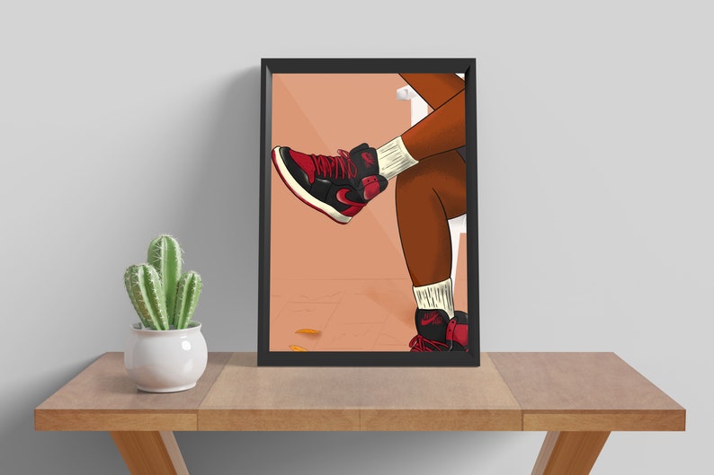 May include: A framed illustration of a person's legs wearing red and black sneakers with white socks. The background is a peach color.