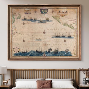 May include: A vintage map of the Pacific Ocean with the text "MAR PACIFICO" in red lettering. The map is framed in a wooden frame and hangs on a white wall above a bed with a brown headboard.