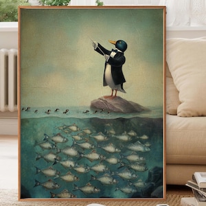 May include: A framed art print depicts a penguin conductor leading a school of fish. The penguin, in a tuxedo, stands on a rock, conducting with a baton. The artwork has a vintage, whimsical style with a muted color palette.