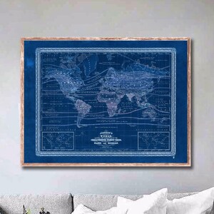 May include: A vintage world map print in a blue and white color scheme. The map is framed in a light brown wood frame. The map shows the continents and oceans of the world. The map is titled "Johnson's World Chart Embracing the Most Recent Discoveries Made in 1858."