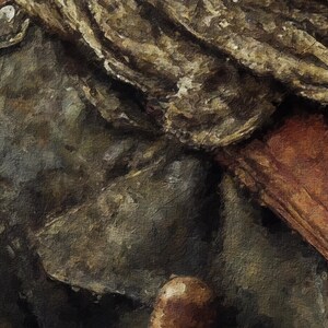 Op de afbeelding: Een close-up van een textuurrijke, bruine stof met een lichtere bruine stof die eroverheen is gevouwen. De stof heeft een ruwe, versleten uitstraling.