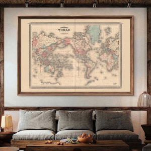 May include: An antique world map print in a brown wooden frame. The map is in a vintage style with faded colors and detailed lines. The title of the map is "Johnson's World" and it includes the words "Meridian Distance" and "Longitude."