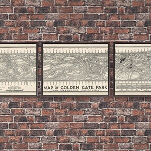 May include: Three framed vintage maps of Golden Gate Park in San Francisco, California. The maps are in black and white and show the layout of the park, including roads, paths, and buildings. The maps are displayed on a brick wall.