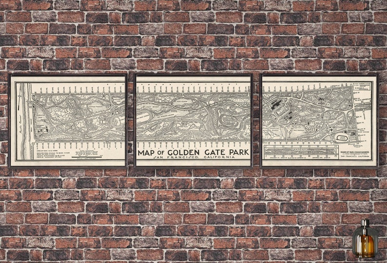 May include: Three framed vintage maps of Golden Gate Park in San Francisco, California. The maps are in black and white and show the layout of the park, including roads, paths, and buildings. The maps are displayed on a brick wall.