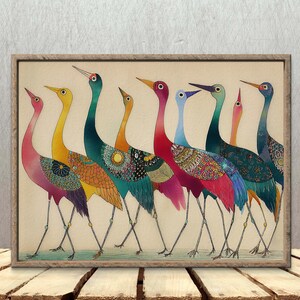May include: A framed art print featuring a line of stylized birds with long necks and legs. The birds are depicted in a variety of colors, including pink, yellow, teal, and blue, with patterned details on their bodies. The artwork is set against a cream-colored background.