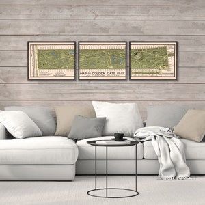 May include: Three framed vintage maps of Golden Gate Park in San Francisco, California. The maps are in black frames and are hanging on a wood wall.