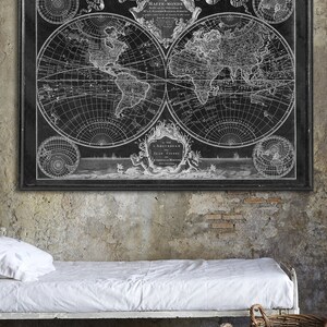 May include: A black and white vintage world map print with an ornate frame. The map is titled "Mappe-Monde" and features the text "Amsterdam chez Jean Covens."