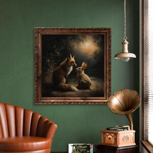 May include: A framed painting depicts a fox and a rabbit in a forest setting. The artwork is in a brown ornate frame, hanging on a dark green wall. A vintage gramophone and a brown leather armchair are also in the room.