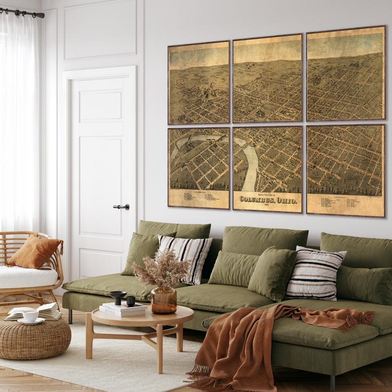 May include: A living room with a green sectional sofa, a coffee table, and a wicker chair. The wall behind the sofa is decorated with a vintage map of Columbus, Ohio, divided into six panels.