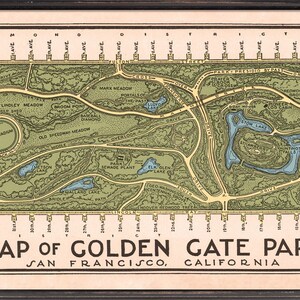 May include: A vintage map of Golden Gate Park in San Francisco, California. The map shows the layout of the park, including roads, lakes, and landmarks. The map is printed in green, brown, and blue colors.