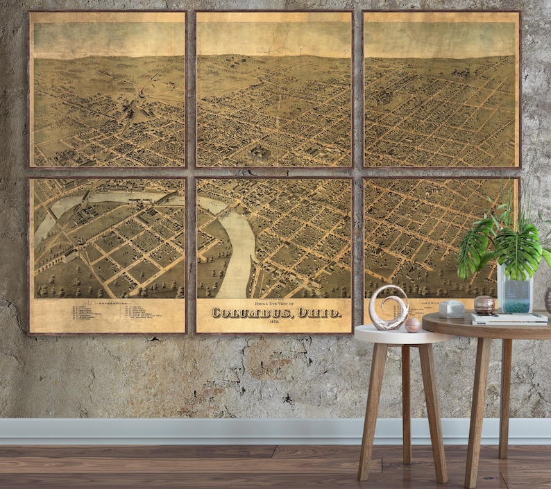 May include: An antique map of Columbus, Ohio, divided into six sections, showing the city's layout in 1875. The map is printed on aged paper with a brown and beige color scheme. The map is framed and displayed on a wall.