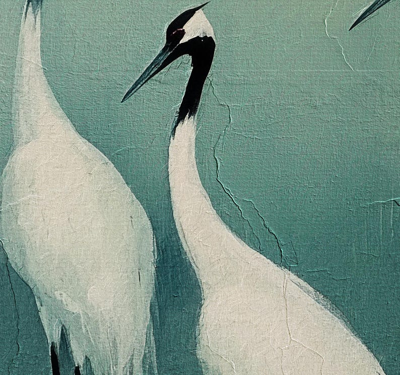 May include: Two white cranes with black heads and necks stand against a teal green background. The cranes are facing different directions. The background has a textured, cracked appearance.