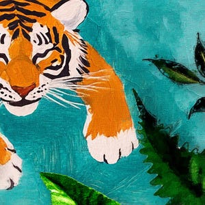 May include: A close-up of a tiger's face with orange and black stripes, looking directly at the viewer. The tiger is painted on a teal background with green leaves.