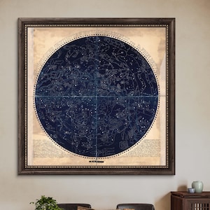 May include: A vintage star chart with constellations and Latin text in a dark blue and cream color scheme. The chart is framed in a dark wood frame.