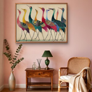 May include: A framed artwork featuring a line of colorful birds with long necks and legs. The birds have a variety of colors, including pink, yellow, teal, and red. The artwork is displayed on a pink wall.