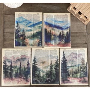 May include: Five watercolor paintings of mountain landscapes with trees and a blue sky. The paintings are on a vintage dictionary page background.