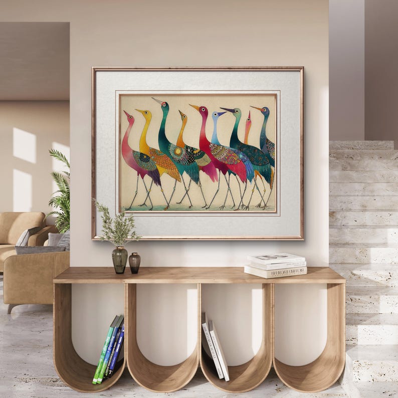 May include: A framed artwork featuring a line of colorful birds with long necks and legs. The birds have a variety of patterns and colors, including pink, yellow, blue, and green. The artwork is displayed above a wooden console table.