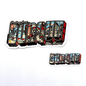 May include: Two stickers with the text "Greetings from BURQUE New Mexico". The stickers have a 3D effect with a variety of images inside the letters, including a hot air balloon, a motel sign, and buildings.