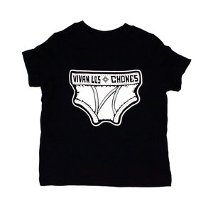 May include: Black t-shirt featuring a white graphic of underwear with the text "VIVAN LOS CHONES" in a rectangular frame. The underwear graphic has stitched details and vertical lines.