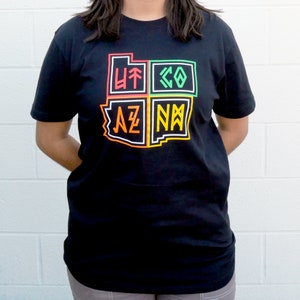 May include: Black t-shirt with a graphic of the states of Utah, Colorado, Arizona, and New Mexico. The states are outlined in different colors and the state abbreviations are inside each state.