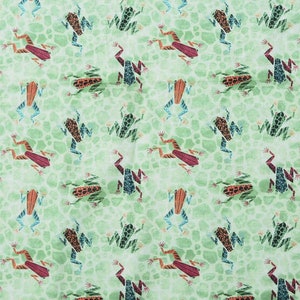 May include: A green fabric with a repeating pattern of colorful frogs. The frogs are in various poses, including sitting, jumping, and swimming. The fabric is perfect for crafting projects, such as making bags, pillows, and quilts.