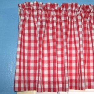 May include: Red and white gingham valance with a ruffled top edge.