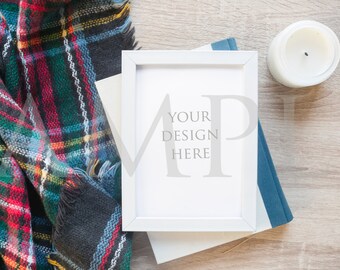 Download Free white frame Mockup stock photo on wood with candle and plaid blanket scarf and journal PSD Template