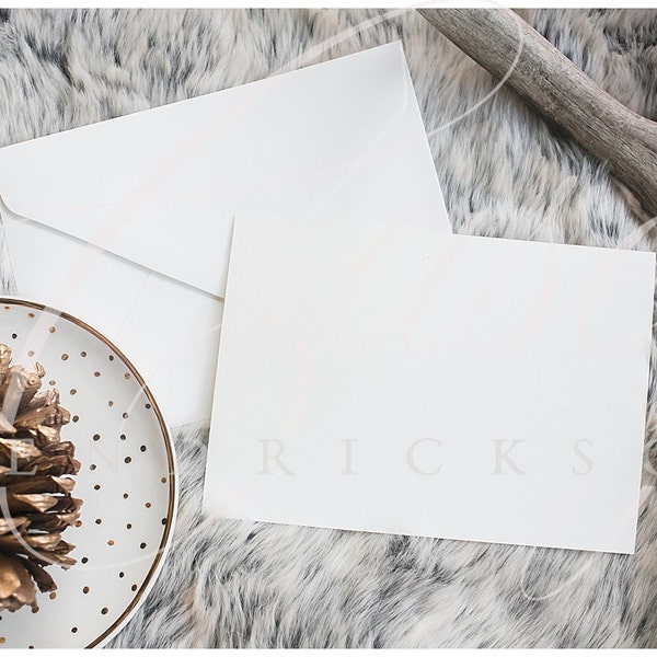 Horizontal Blank stationery invitation holiday christmas card mockup stock photo on gray fur w/ polkadot plate and gold pinecone and antler