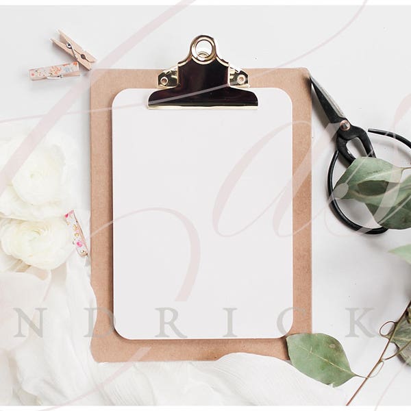 Clipboard with greenery and flowers and scissors mockup stock photo for office
