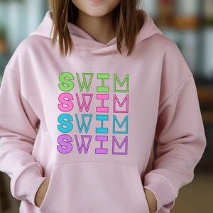 May include: Pink hoodie with the word "SWIM" repeated four times in different colors: green, pink, blue, and purple.